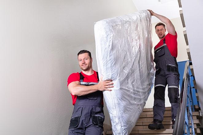 furniture removal service hauling away a box spring in Ottawa